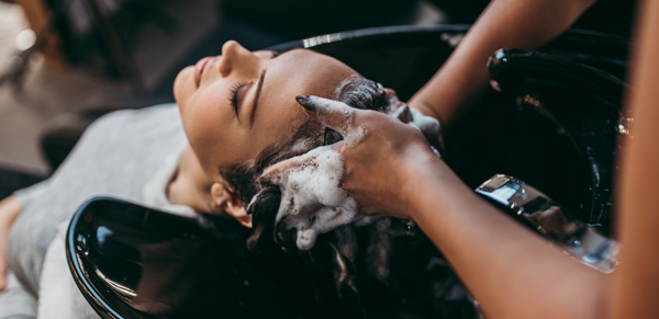Woman getting hair washed at the hairdressers